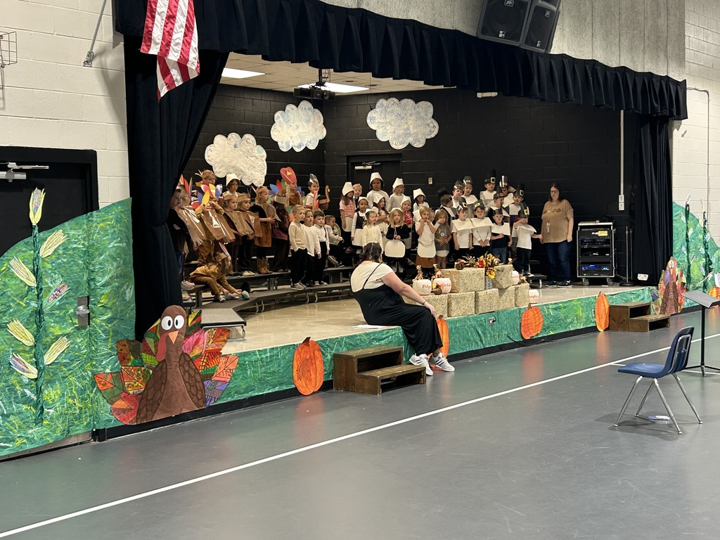 Students in thanksgiving costumes on a stage