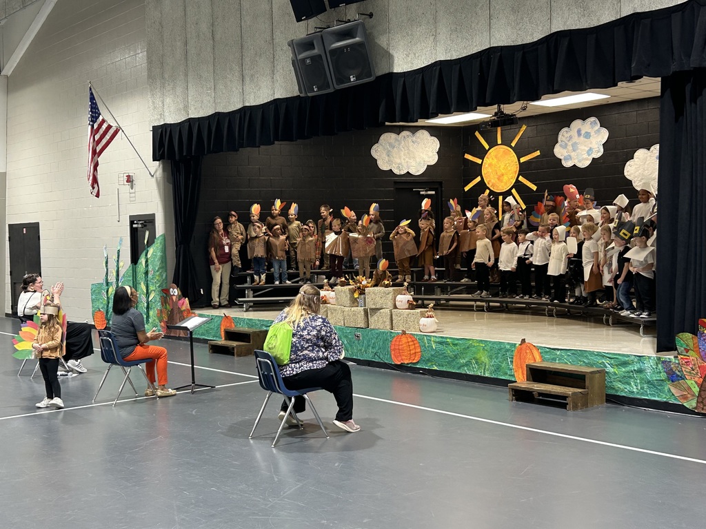 Students in thanksgiving costumes on a stage