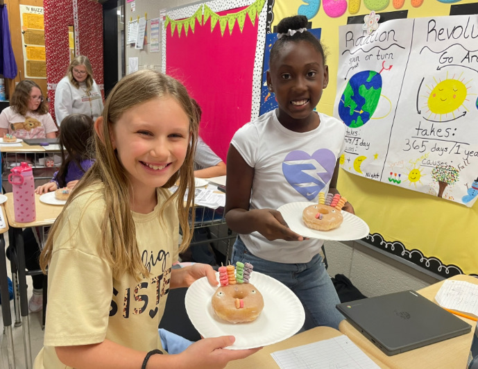 4th grade math is fun with donut turkeys!  picture of kids posing with their donut turkeys 