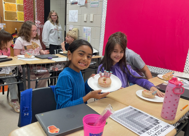 4th grade math is fun with donut turkeys!  picture of kids posing with their donut turkeys 