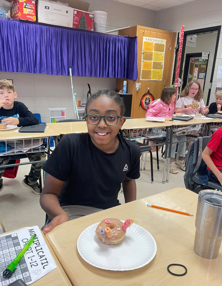 4th grade math is fun with donut turkeys!  picture of kids posing with their donut turkeys 