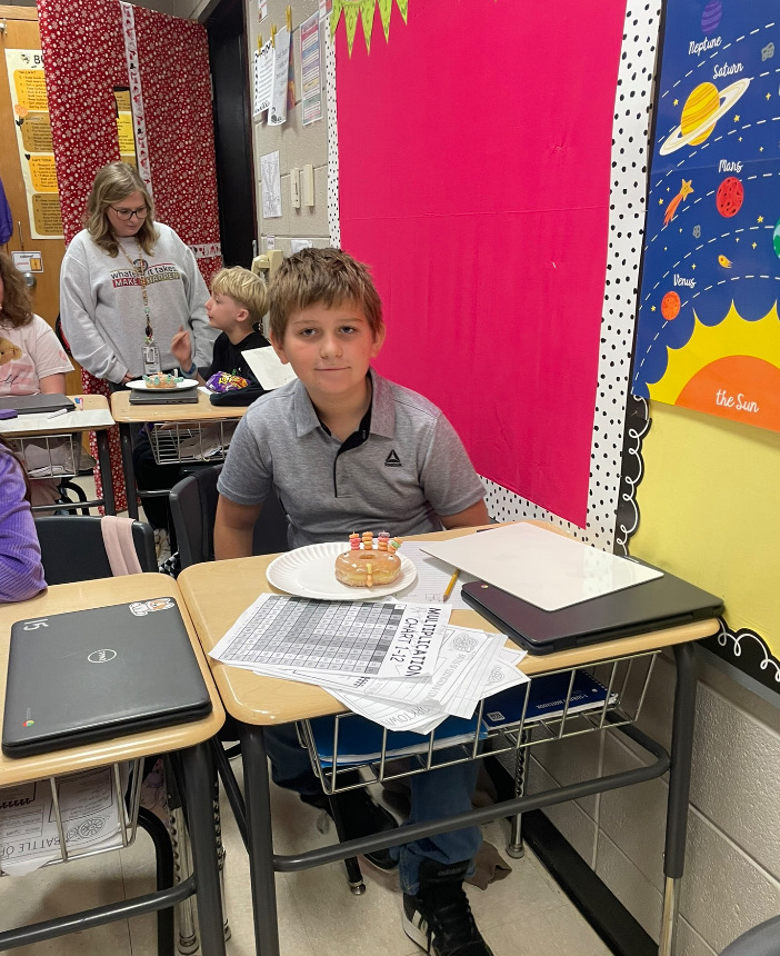 4th grade math is fun with donut turkeys!  picture of kids posing with their donut turkeys 