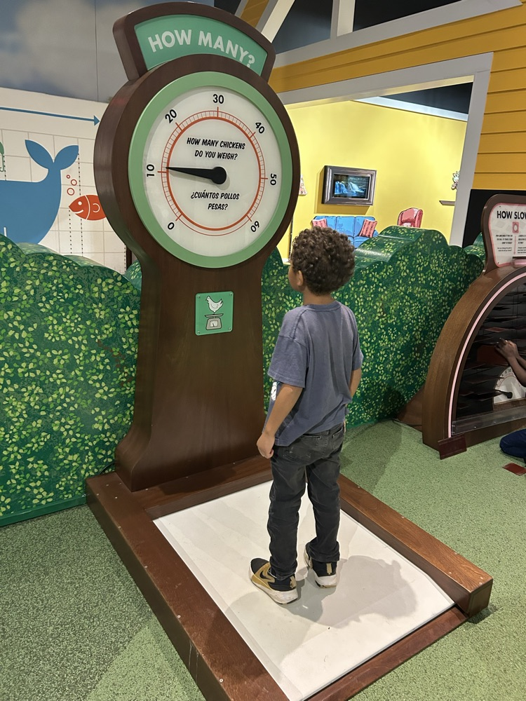 a student standing on a big scale 