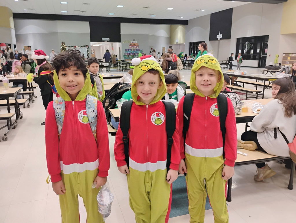 Students posing for the camera in their grinch attire. 