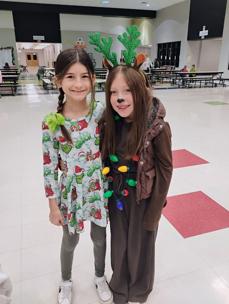 Students posing for the camera in their grinch attire. 