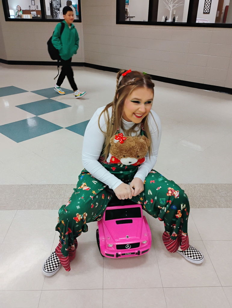 Mrs. Haynes as Cindy Lou Who. driving a small pink car. 
