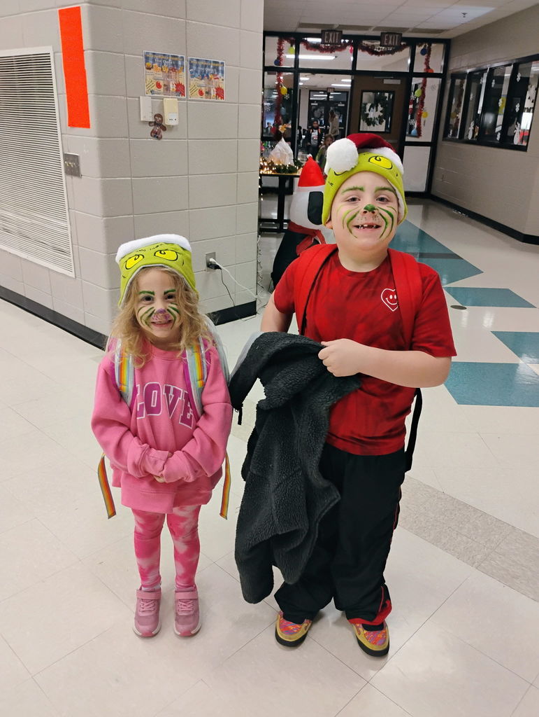 Students posing for the camera in their grinch attire. 