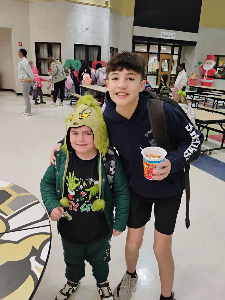 Students posing for the camera in their grinch attire. 