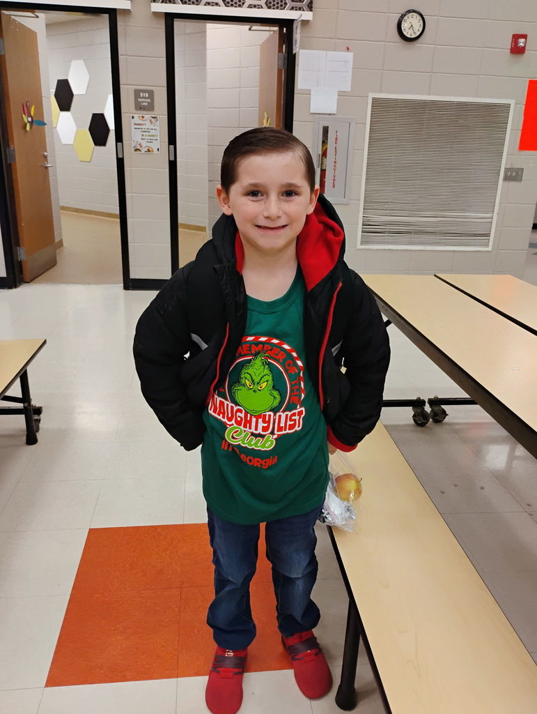 Students posing for the camera in their grinch attire. 