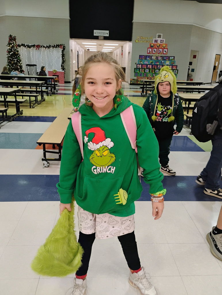 Students posing for the camera in their grinch attire. 