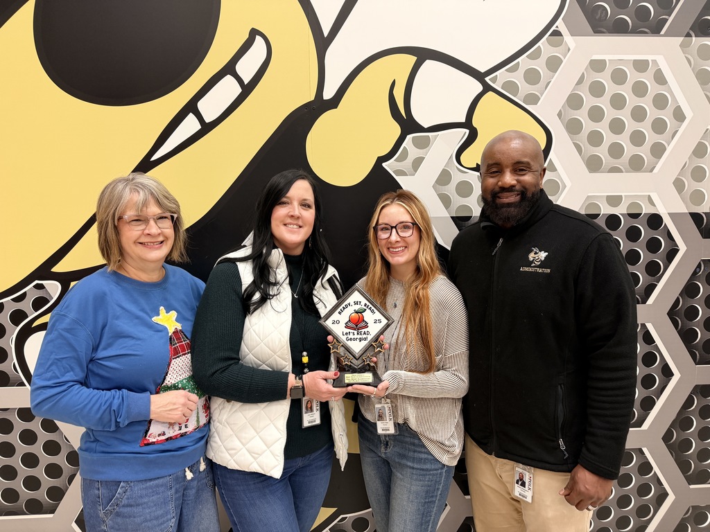 5th grade ELA teachers posing with Mr. Z and the trophy for winning the state comp. 