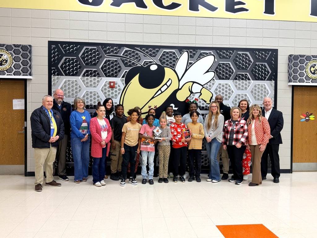 Van Wert staff, administrators, RESA staff, and students posing with the RESA trophy for winning a state comp. 