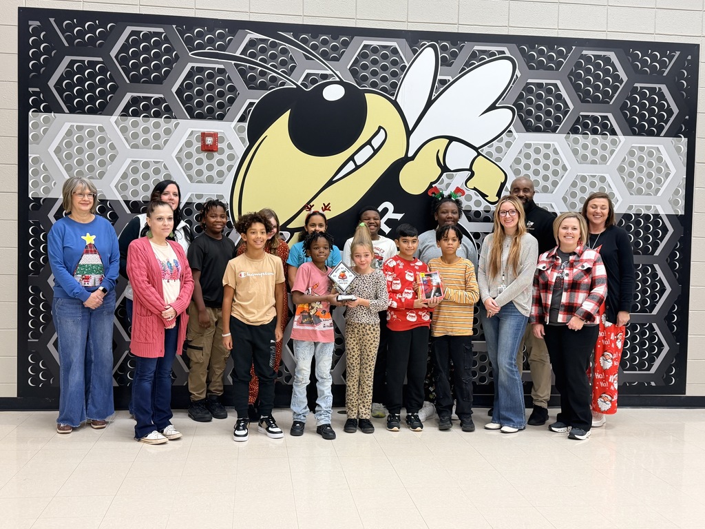 Van Wert staff, administrators, and students posing with the RESA trophy for winning a state comp. 