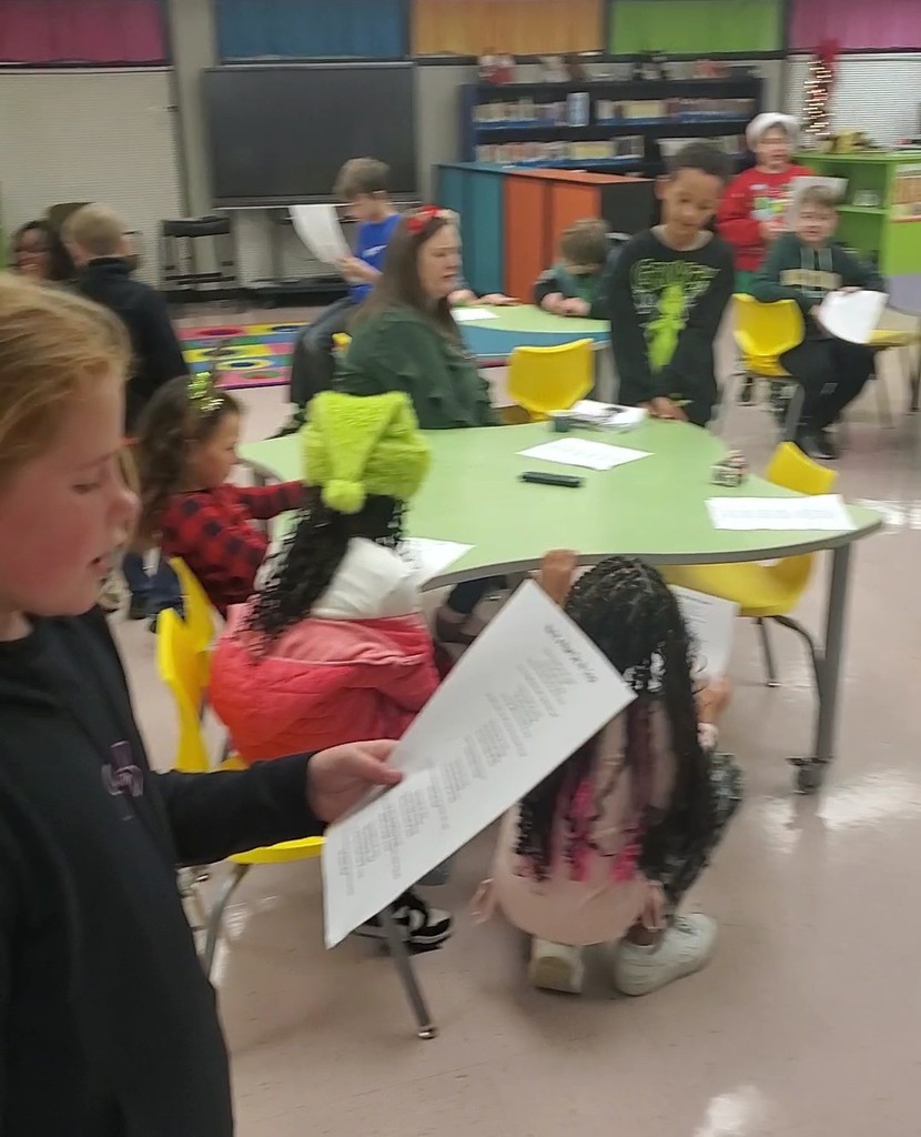 Students caroling in the library