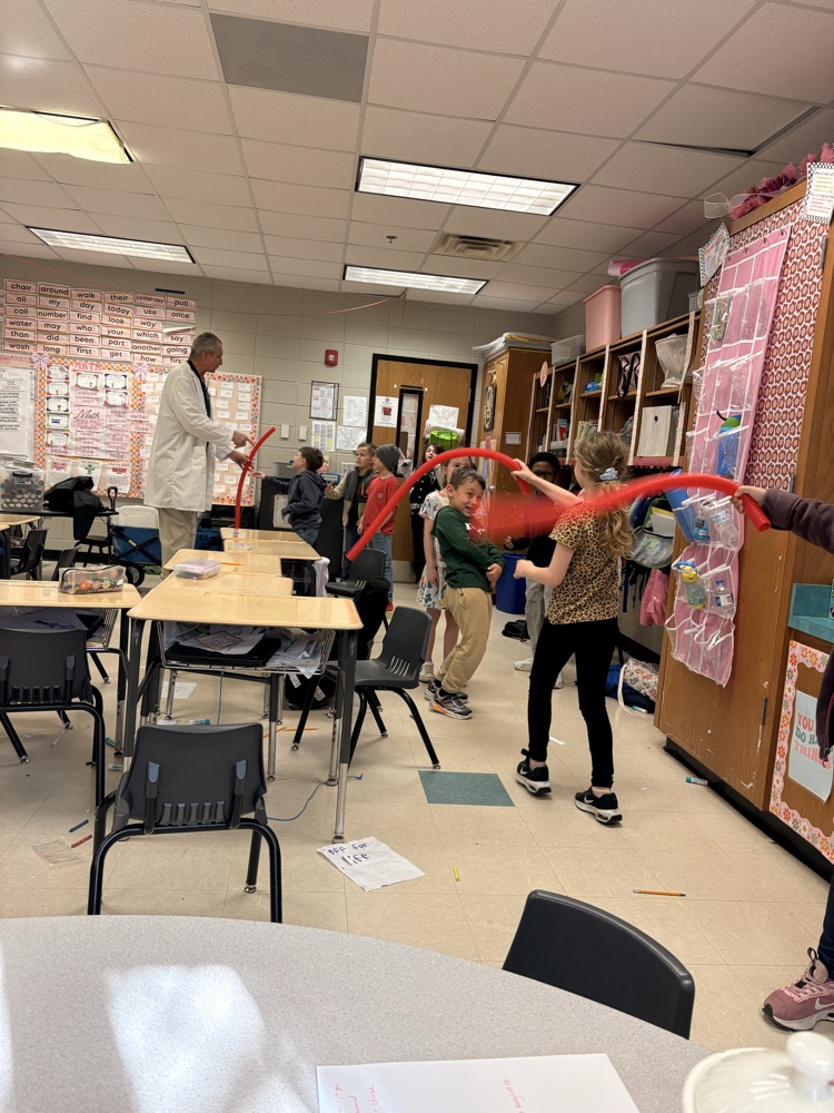 picture of students experimenting with sound and objects to make sound