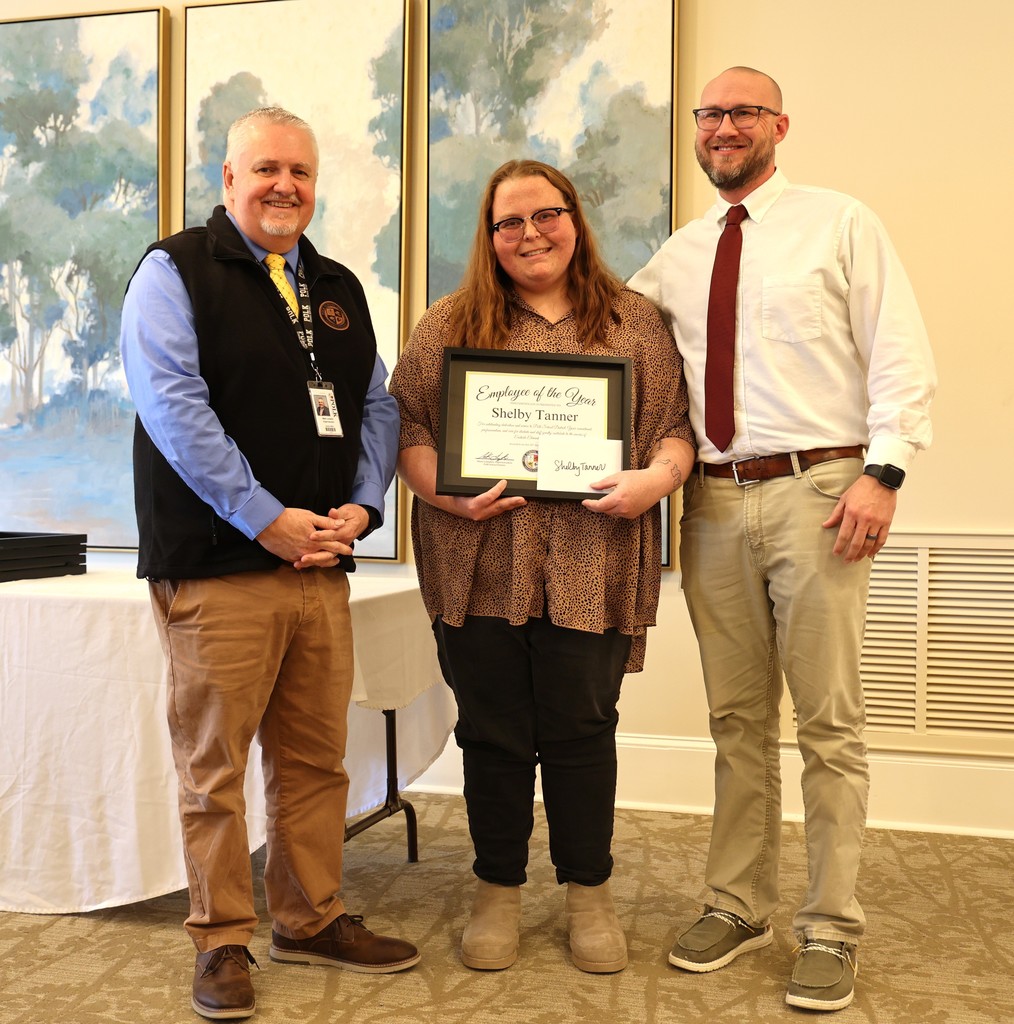 School Superintendent, Mark Lumpkin, and Eastside principal, Ryan Shepard stand with Employee of the Year, Shelby Tanner at a luncheon to honor School Employees of the Year.