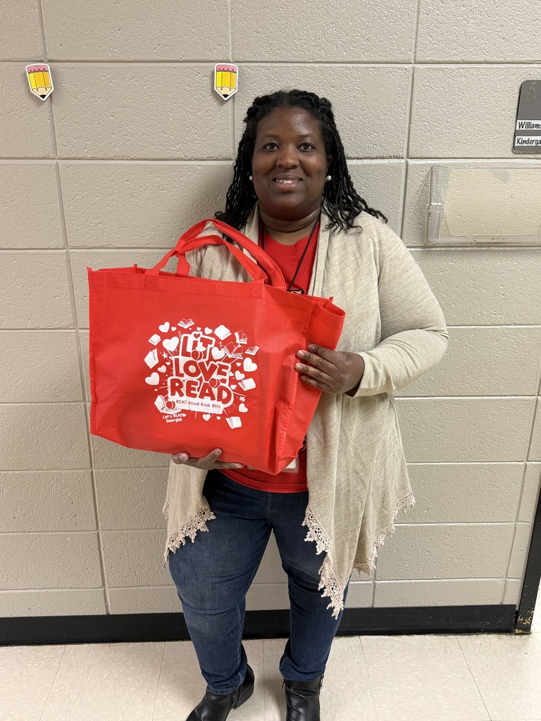 Ms. Williams posing with her gift from the drawing. :)