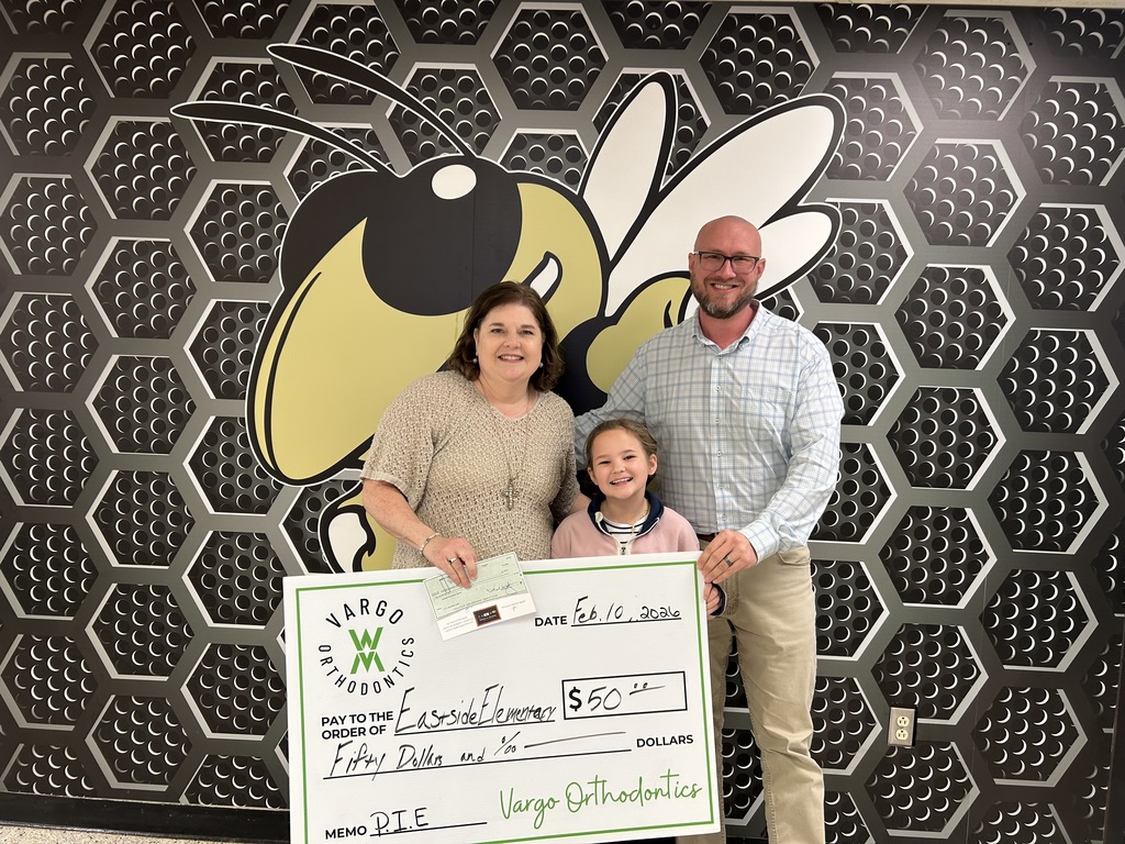 Ragin with Mrs Wilson and Mr Shepard accepting a donation from Vargo Orthodontics