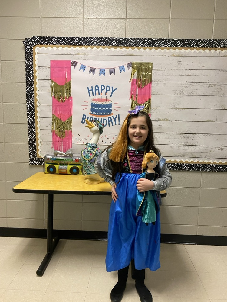picture of a student posing in front of the goose.  