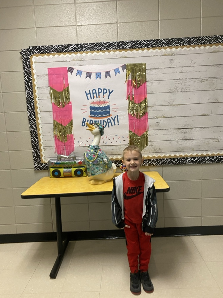 picture of a student posing in front of the goose.  