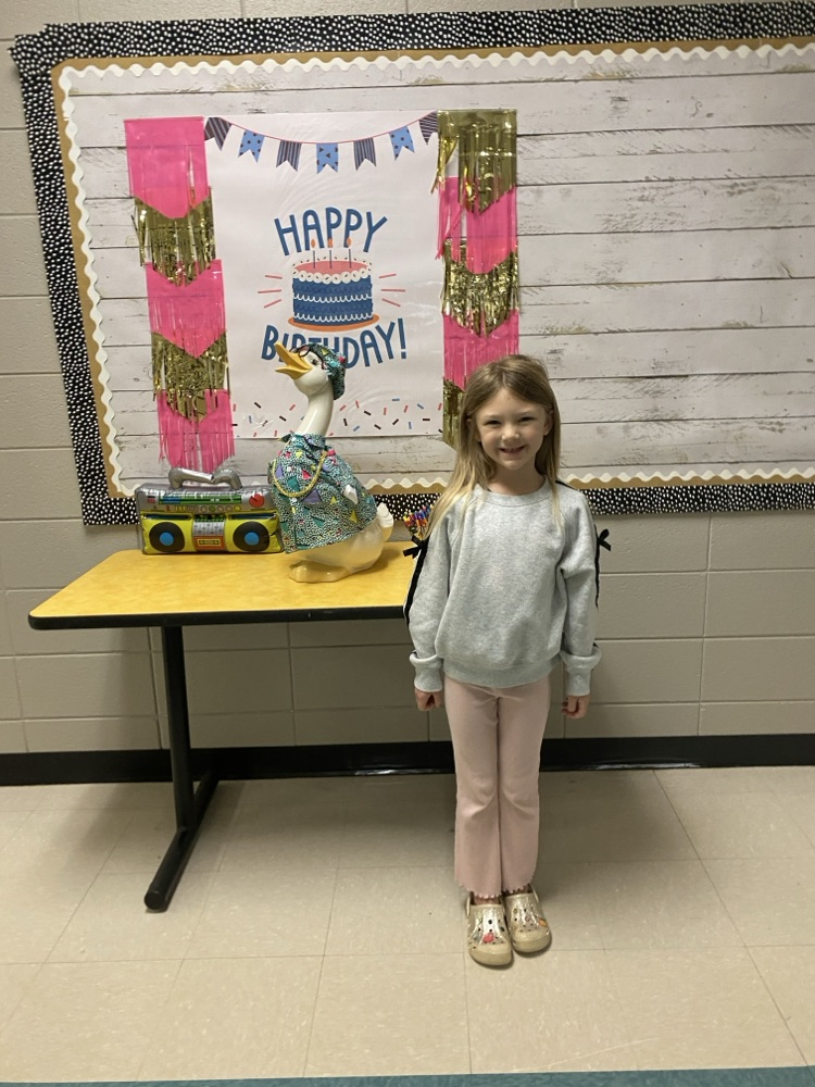 picture of a student posing in front of the goose.  