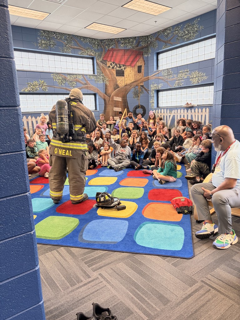 Ms. O'Neal's father talking to 2nd graders about being a fire fighter. 
