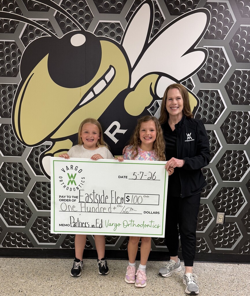 Students pose with donation check from Vargo Orthodontics 