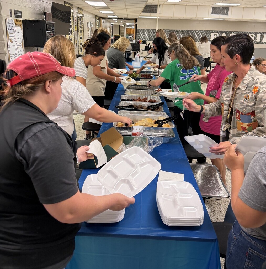 Teachers and staff serving breakfast