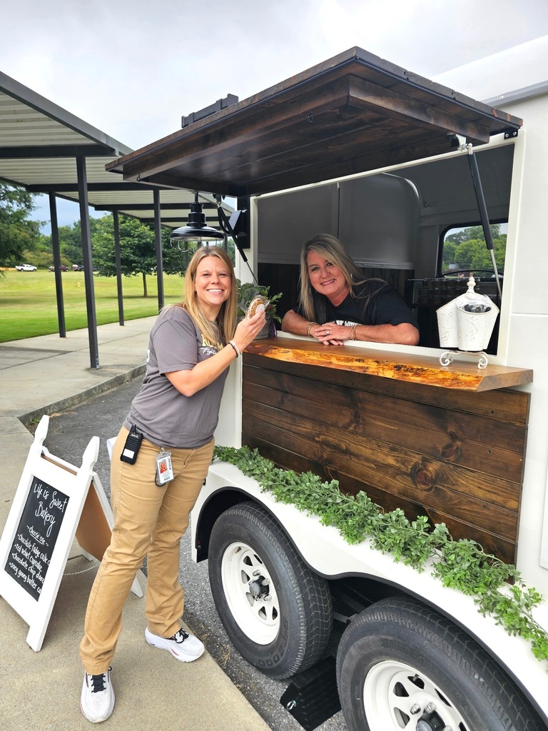 Mrs. Smith posing with treats from Mrs. Morris' Life is Sweet mobile stand. 