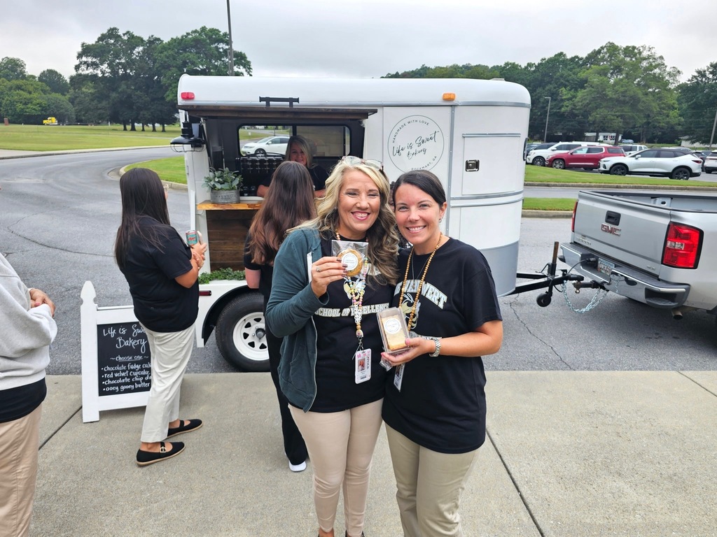 Our teachers posing with treats from Mrs. Morris' Life is Sweet mobile stand. 