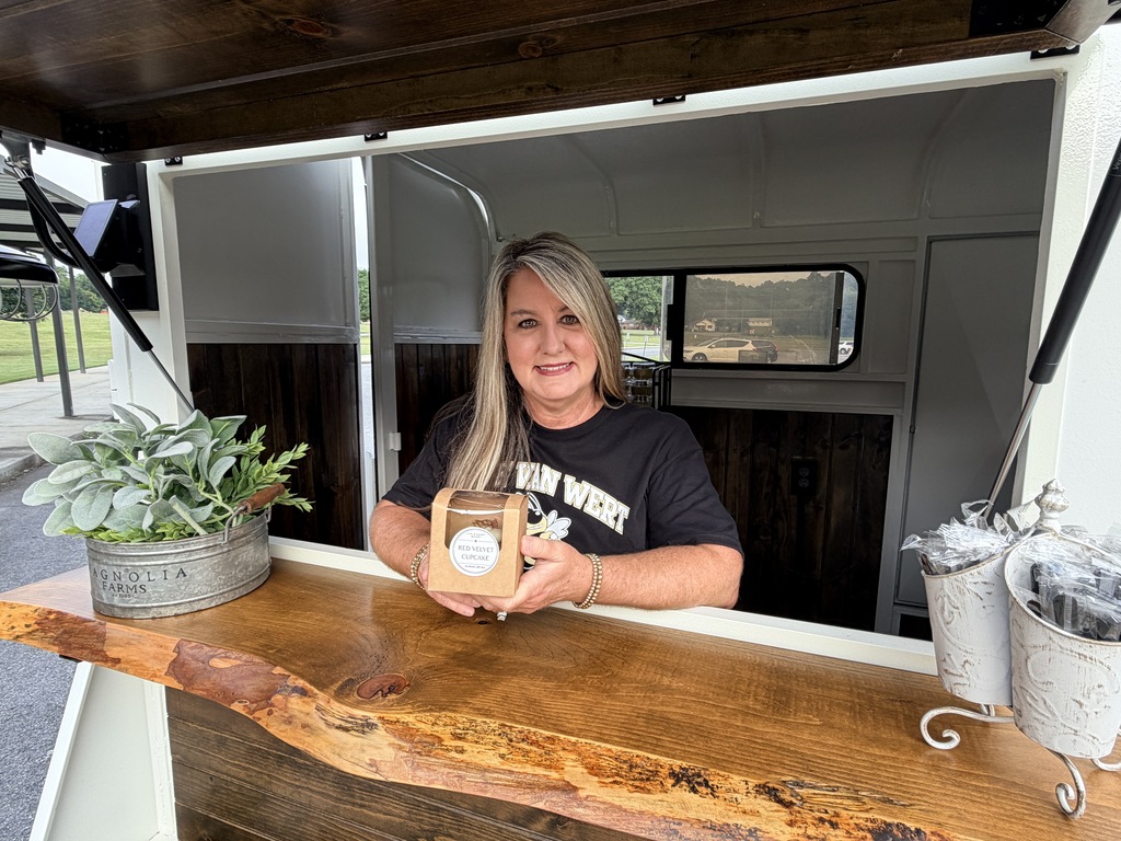 Mrs. Morris posing inside of her mobile sweets stand.
