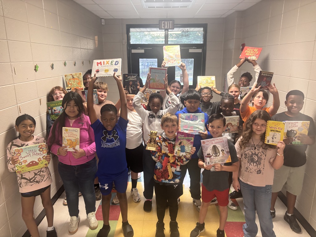 5th grade students posing with the GOAT trophy!