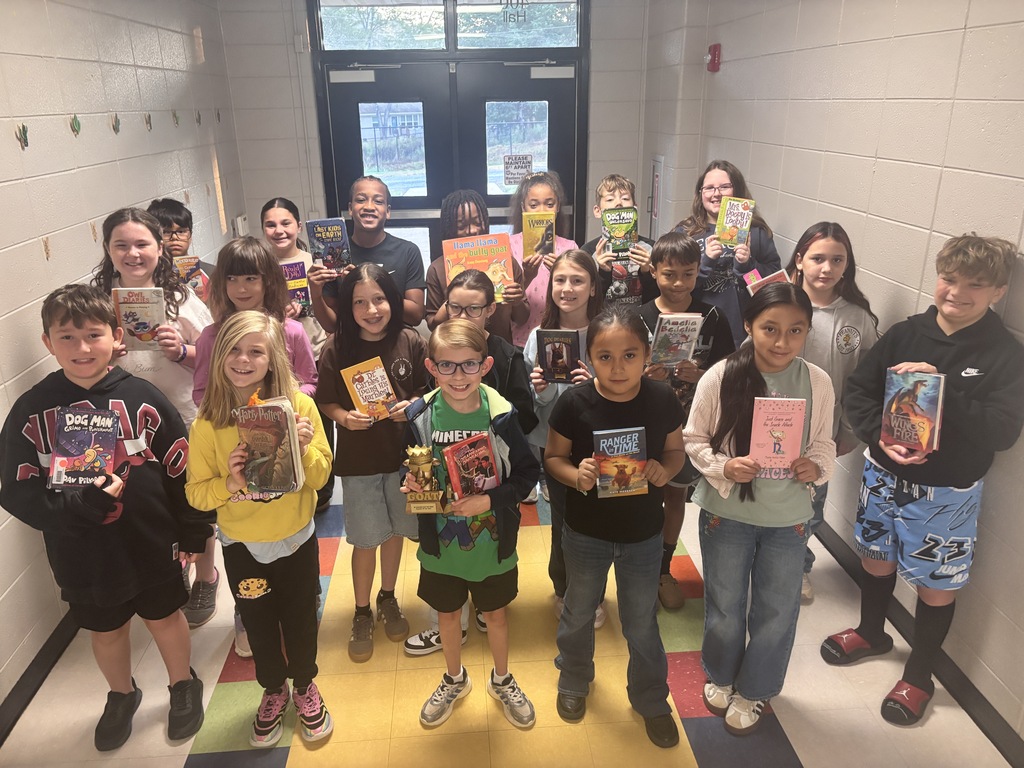 5th grade students posing with the GOAT trophy!