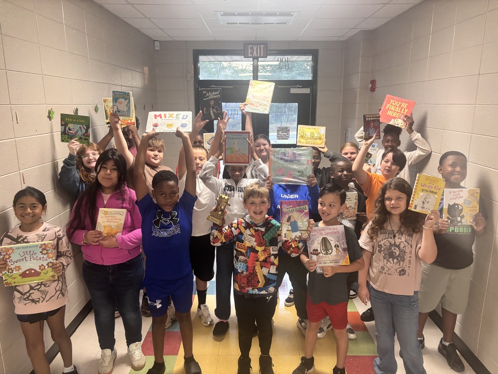 5th grade students posing with the GOAT trophy!