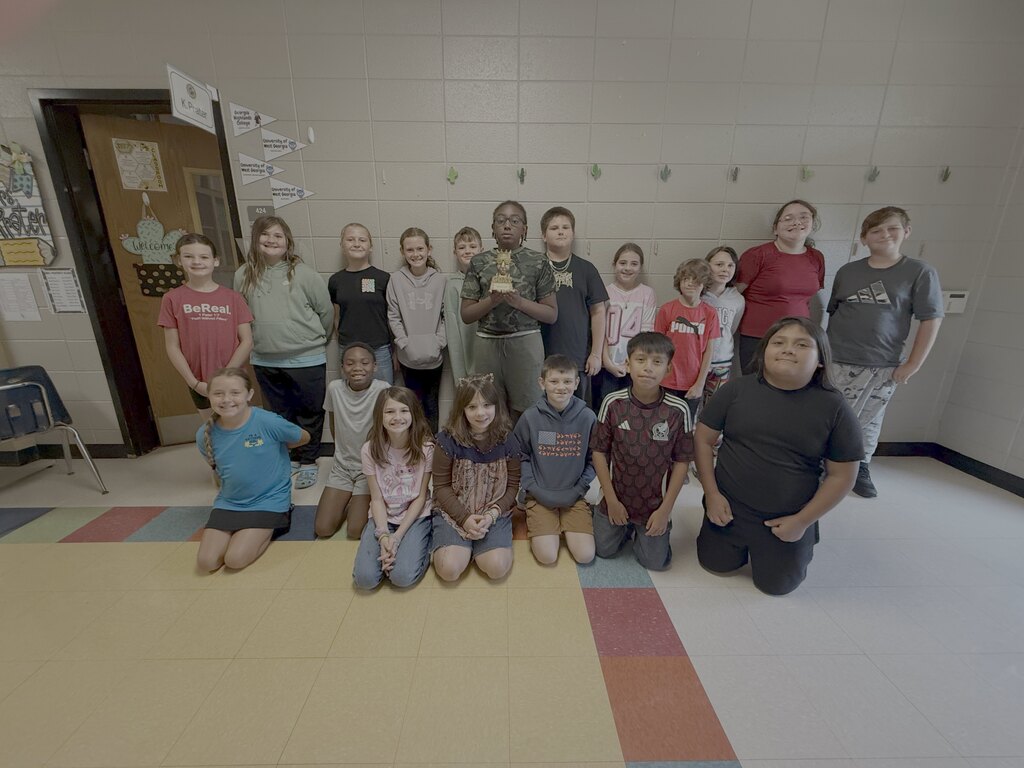 5th grade students posing with the GOAT trophy!
