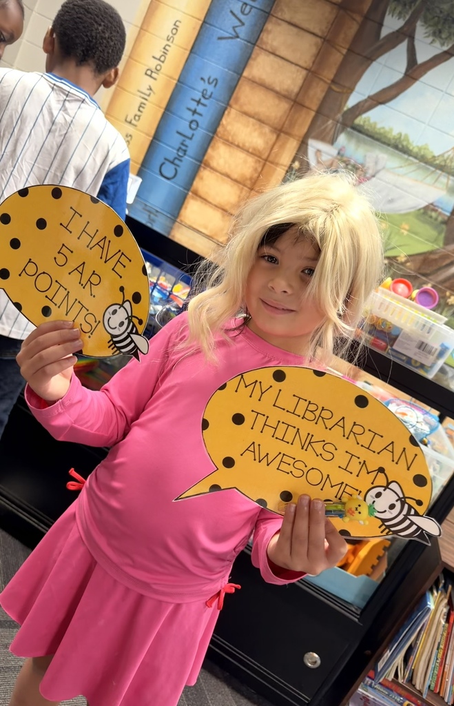 Our first 1st grader earned 5 AR points today! Way to go, Mackenzie!   Picture is of Mackenzie with her sticker and pen prizes and signs