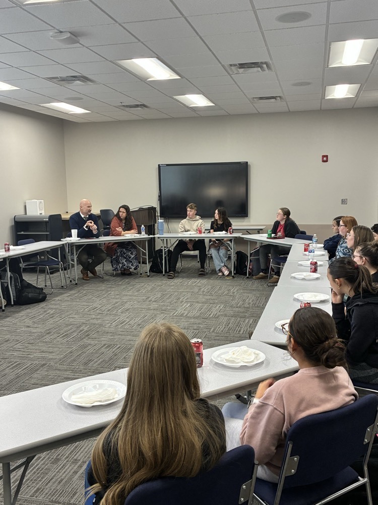 photo of superintendent Adam Leaming talking to 8th grade students