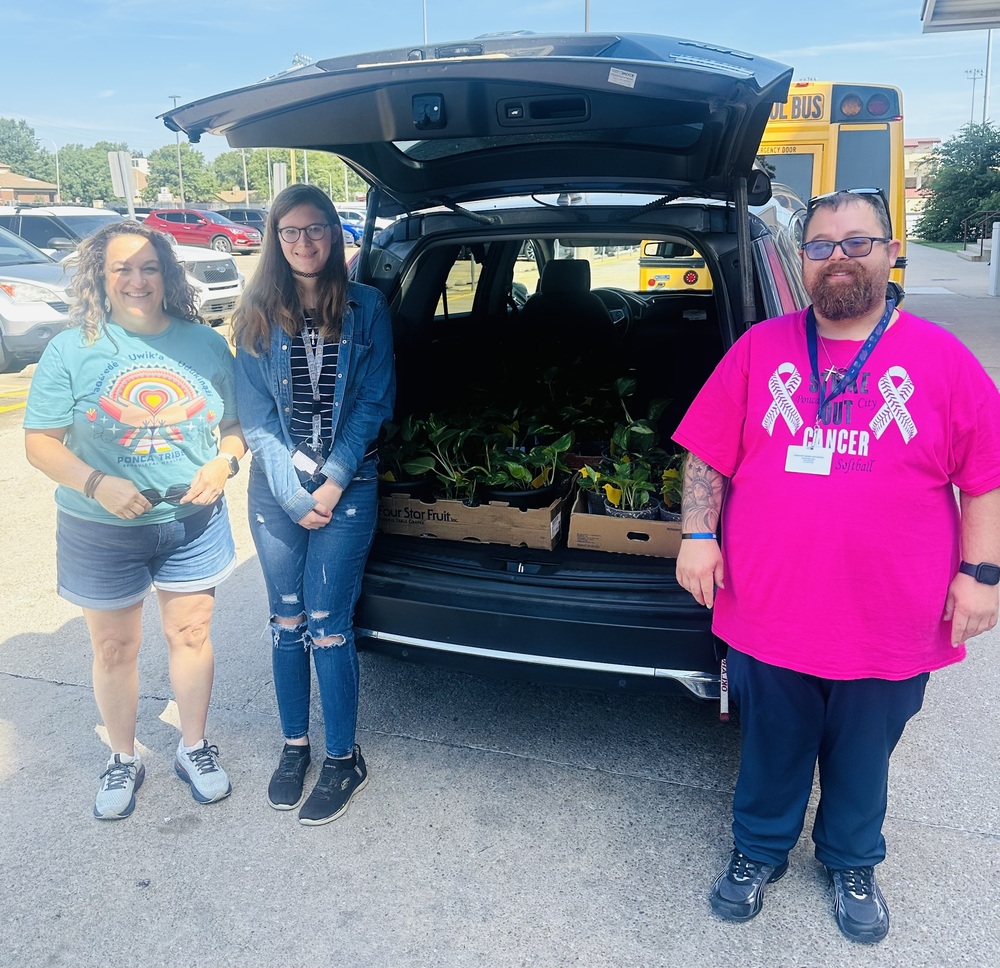 Photo of people with donated plants.