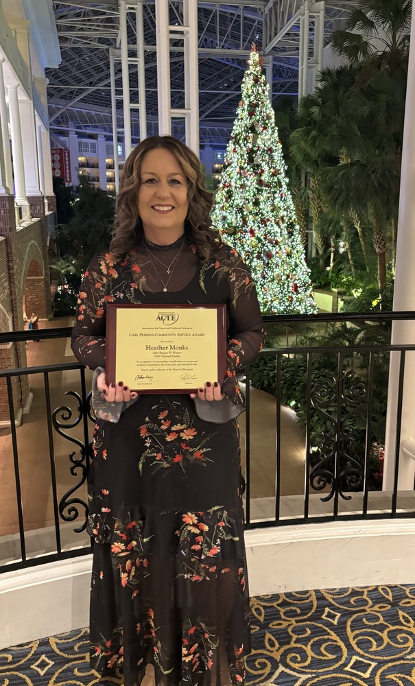 Heather Monks holding Award