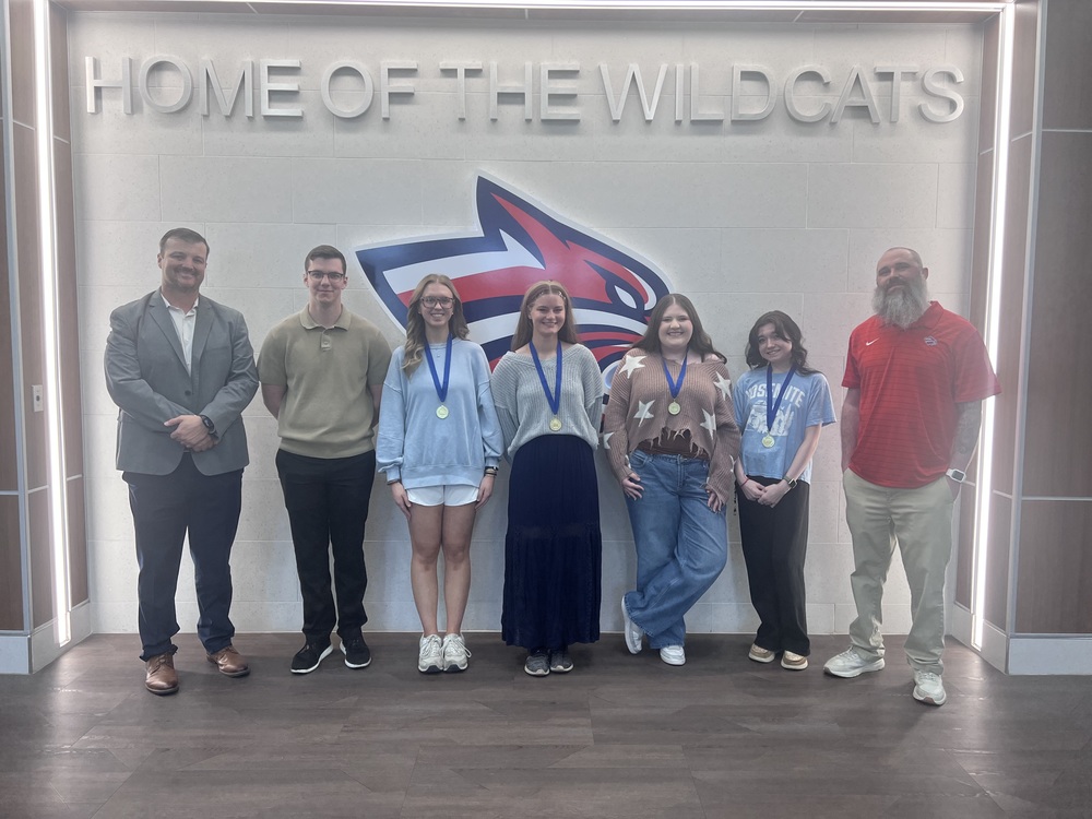 Photo of competitors and teacher/principal