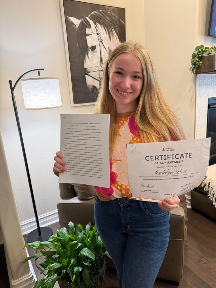 Photo of the student who got the scholarship with her certificate