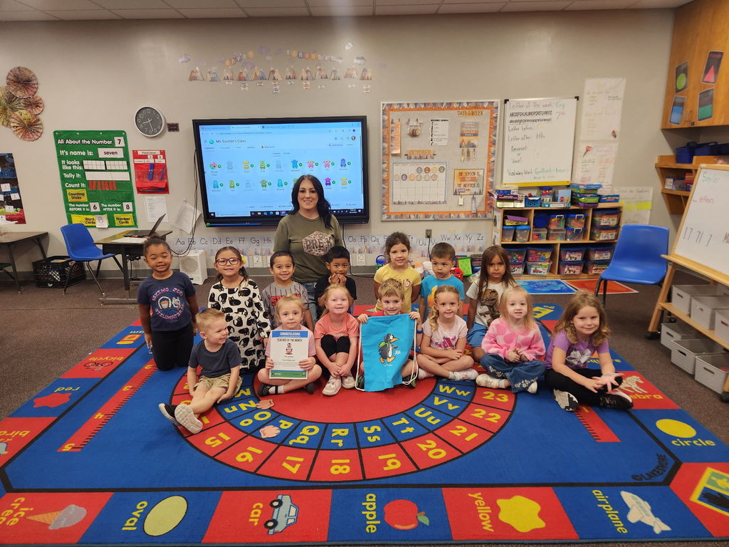 Photo including Mrs. Soutter and her class