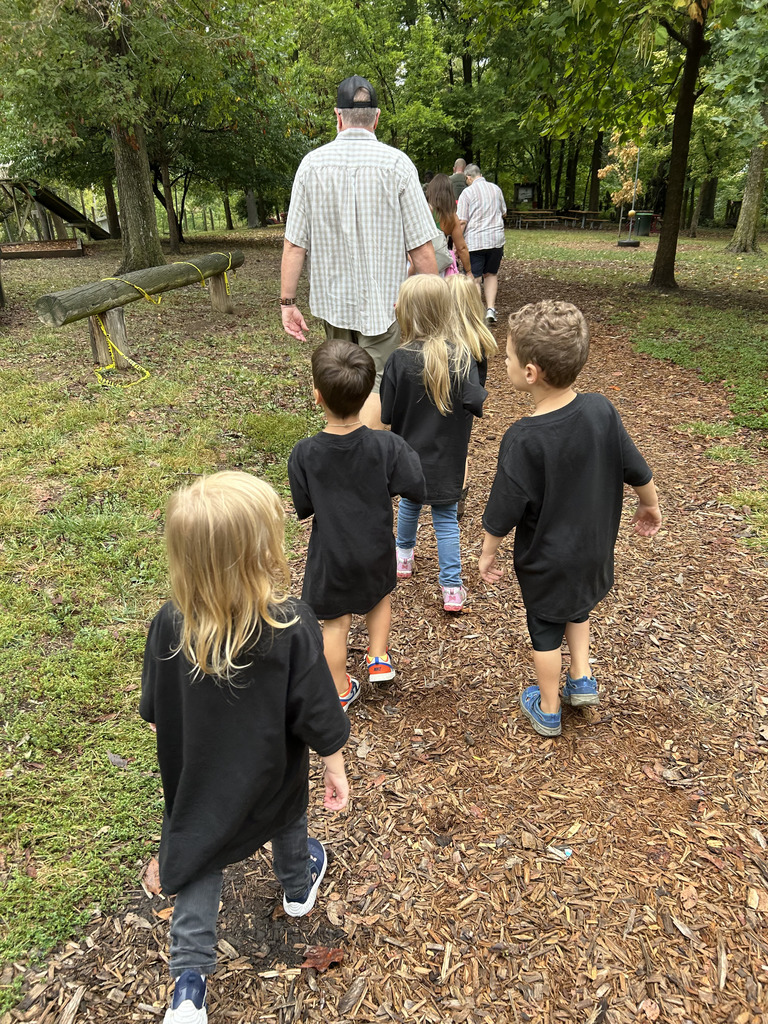 A group of students and parents walking down a mulch path