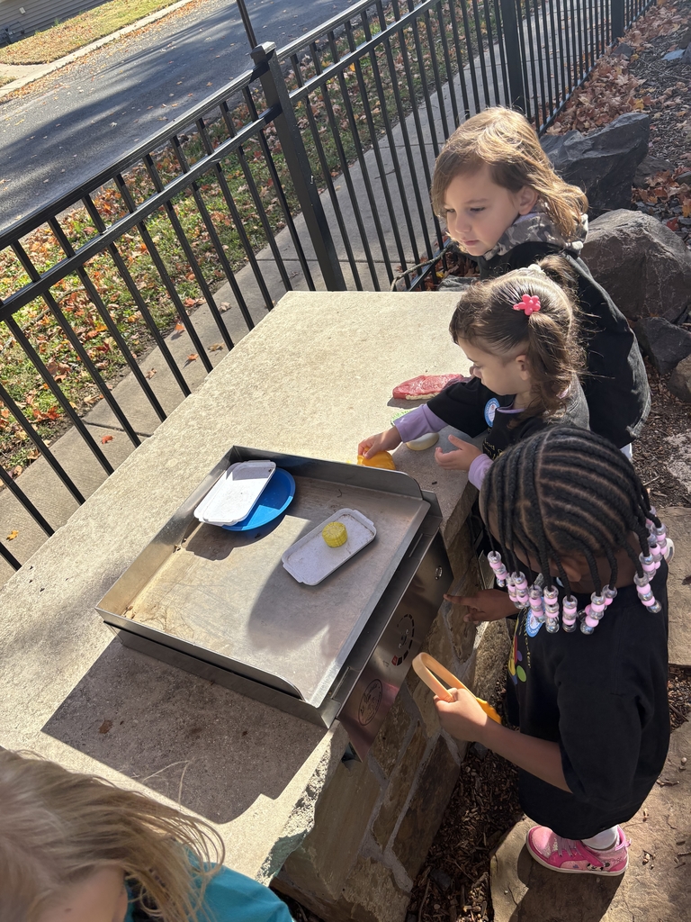 Three girls playing outside with toys