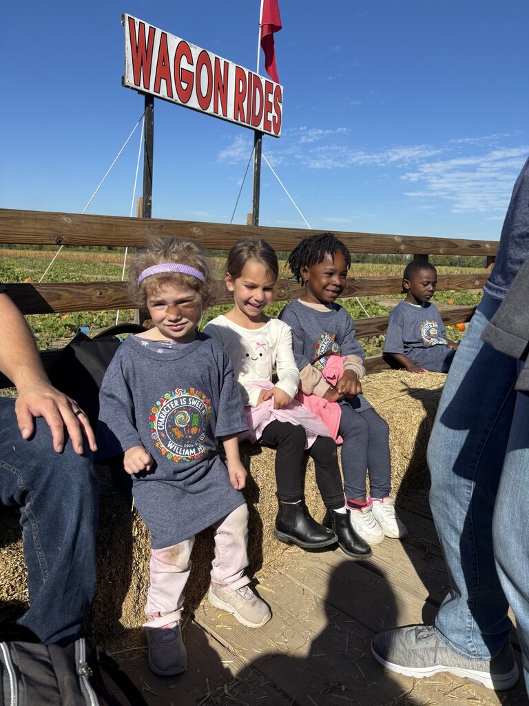 Three girls riding a wagon