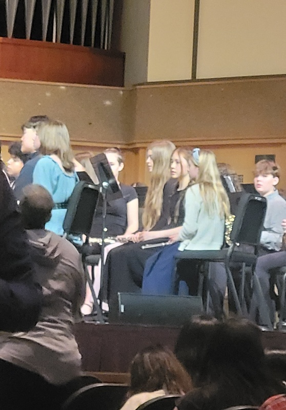 Adelyn amongst the flutes in the honor band
