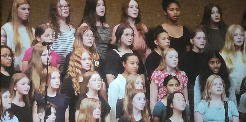 Ava singing with the choir