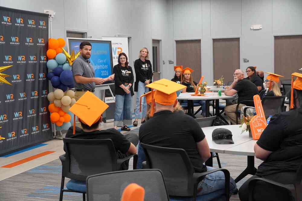 Graduation ceremony with speakers at the front of the room