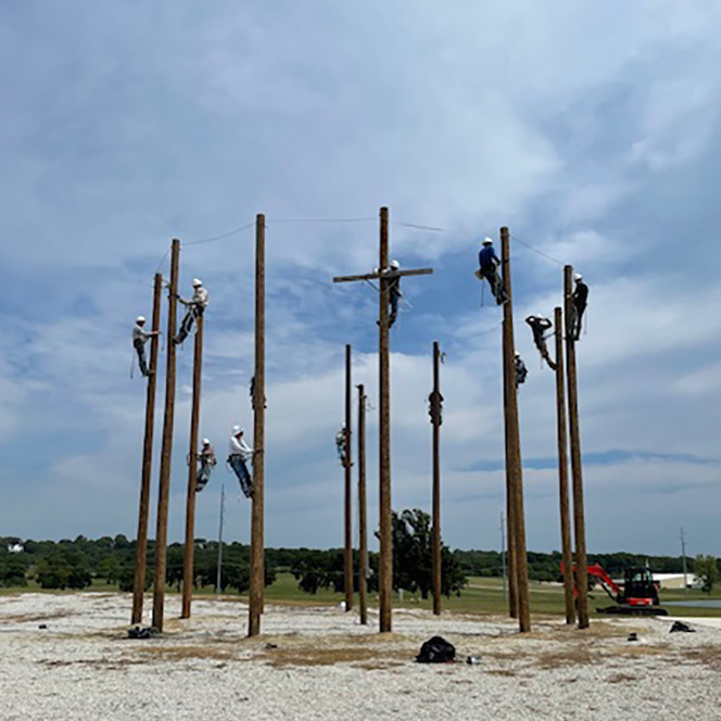 Lineworker Academy students climbing poles