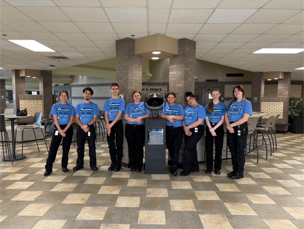Group of students around the success bell.